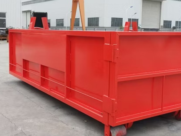 Bright red industrial container positioned at a construction site.