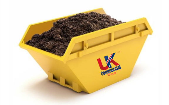 Muck Waste Skip Yellow skip bin filled with muck waste.