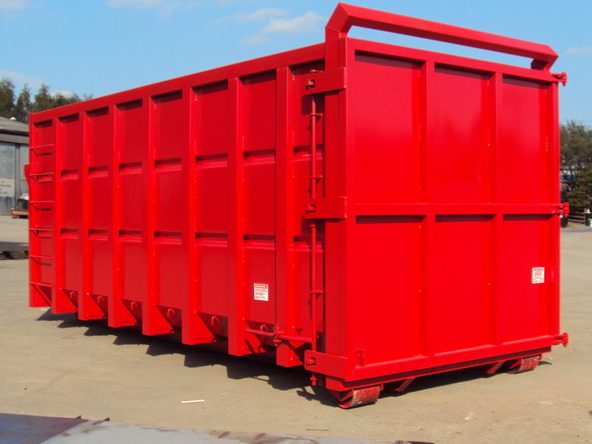 Large red waste container situated outdoors.