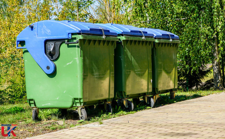 Three wheelie bins in red and blue, featuring the 'UK Commercial Waste logo.